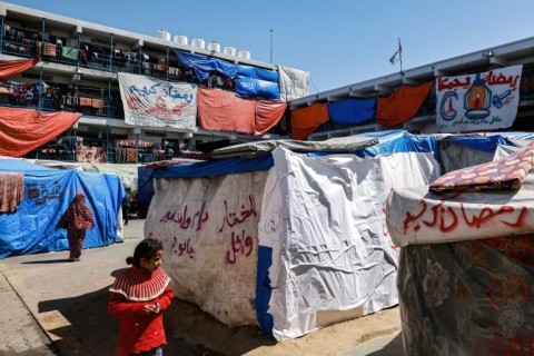 Sheets carry Ramadan greetings at a camp sheltering displaced Palestinians in a school run by the United Nations Relief and Works Agency for Palestine Refugees (UNRWA) in Rafah 