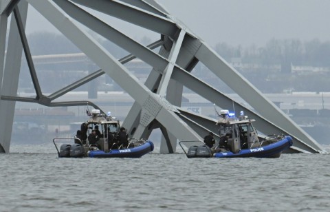 Police recovery crews work near the collapsed Francis Scott Key Bridge in Baltimore after it was struck by the container ship Dali