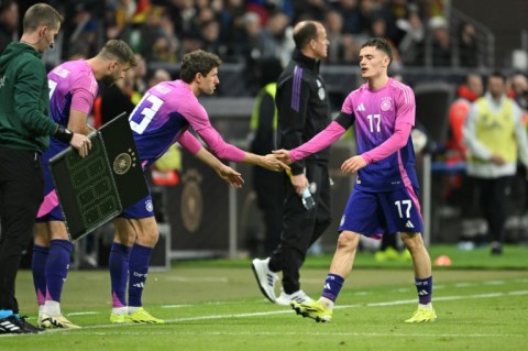 Germany midfielder Florian Wirtz shakes hands with Thomas Mueller in Tuesday's 2-1 win over the Netherlands in Frankfurt