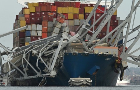 The steel frame of the Francis Scott Key Bridge sits on top of the container ship Dali after the bridge collapsed in Baltimore, Maryland, on March 26, 2024