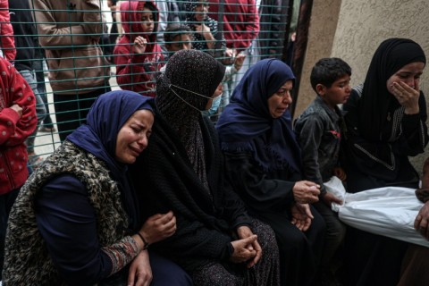 Palestinians at the European hospital in Khan Yunis, southern Gaza, mourn over the body of a child killed in Israeli bombardment
