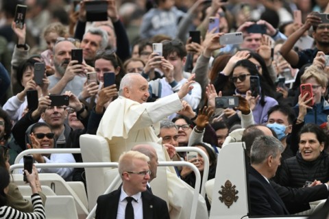 Pope Francis waves to the crowd from the popemobile after  Easter Mass at St Peter's square