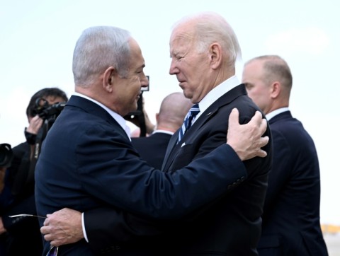 Israel Prime Minister Benjamin Netanyahu (L) greets US President Joe Biden upon his arrival at Tel Aviv's Ben Gurion airport on October 18, 2023