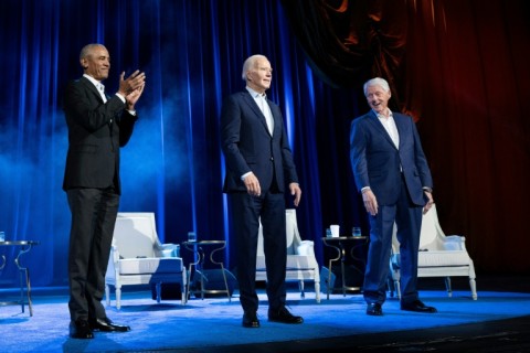 Former US presidents Barack Obama (L) and Bill Clinton (R) cheer for US President Joe Biden (C) at a high-profile fundraiser at Radio City Music Hall in New York City in March 2024