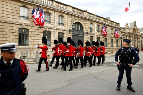 British guards in bearskin hats relieved French counterparts outside the Elysee