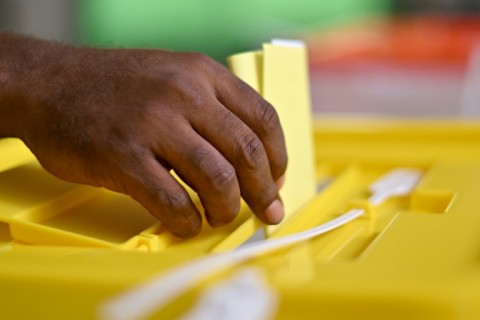 A man drops his ballot paper into the box Wednesday in a Solomons Island vote that will likely decide if the nation deepens ties with China