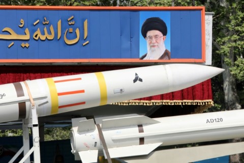 An Iranian military truck carries parts of a Sayad 4-B missile past a portrait of supreme leader Ayatollah Ali Khamenei during a military parade in Tehran on April 17, 2024