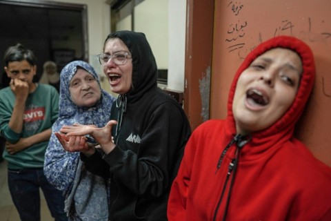 Relatives of the wounded react after an Israeli strike hit central Gaza, doctors at Al-Aqsa Hospital in the Gaza city of Deir El Balah said