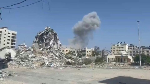Smoke rises over destroyed buildings in Gaza City