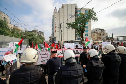 Palestinian Authority police prevent demonstrators from reaching the Canadian Representative Office in the occupied West Bank