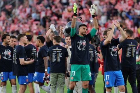 Girona players celebrate their qualification for the UEFA Champions League at the end of beating Barca at Montilivi