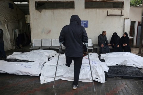 Palestinians mourn by bodies of relatives killed following Israeli strikes on Rafah in the southern Gaza Strip