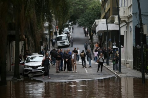 People observe a flooded street at the historical center of Porto Alegre, Rio Grande do Sul state, Brazil 