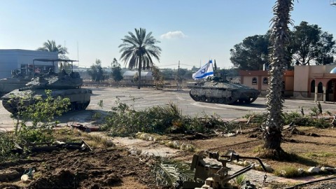 A boy sits amid rubble at the site of a building that was hit by Israeli bombardment in Rafah