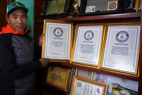 Nepali mountaineer Kami Rita Sherpa, pictured here in 2021, posing with his Guinness World Record certificates for his climbing prowess 