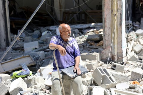 A Palestinian man in front of a destroyed building in north Gaza's Jabalia refugee camp