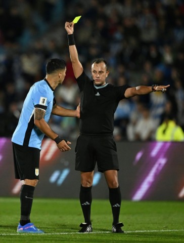 Luis Suarez is shown a yellow card in the final minutes of his last ever international appearance for Uruguay