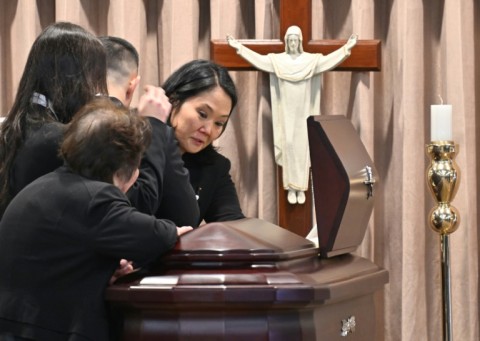 Keiko Fujimori, daughter of late Peru's former president Alberto Fujimori, cries next to the coffin during his state funeral at the Culture Ministry in Lima on September 12, 2024