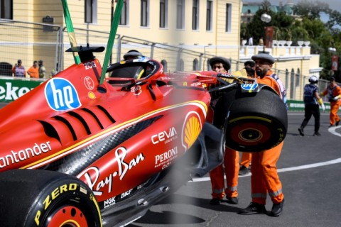 Marshalls remove the damaged Ferrari of Charles Leclerc following a crash during the first practice session for the Azerbaijan Grand Prix