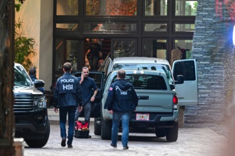 Homeland Security Investigation agents are seen at the entrance of US producer and musician Sean "Diddy" Combs's home at Star Island in Miami Beach on March 25, 2024