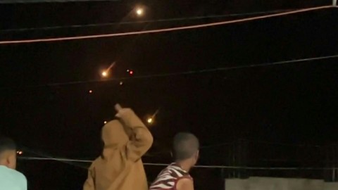 Gazans in Deir el-Balah cheer as they watch a barrage of Iranian missiles fired at Israel