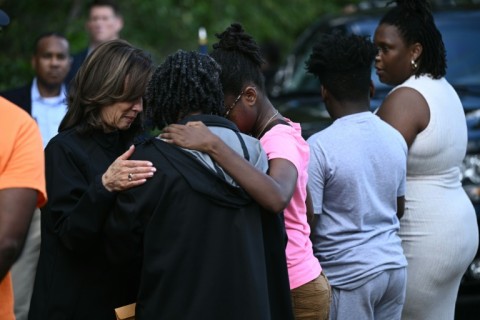 US Vice President Kamala Harris gathers with residents as she surveys the damage from Hurricane Helene, in the Meadowbrook neighborhood of Augusta, Georgia