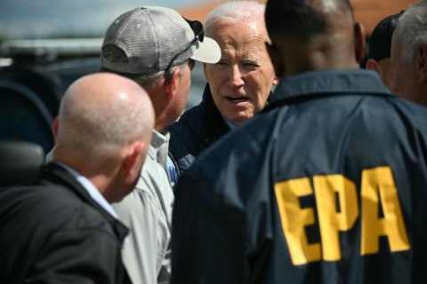 US President Joe Biden speaks with officials as he surveys the damage after Hurricane Helene