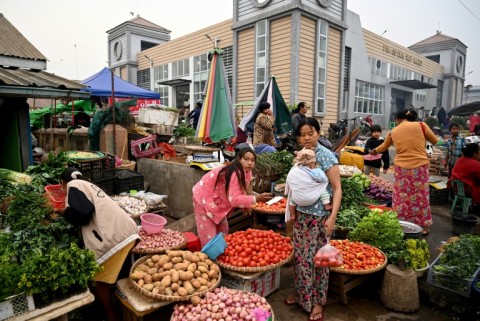 A vendor sells vegetables at a street market in Pyin Oo Lwin township, still in the hands of Myanmar's military