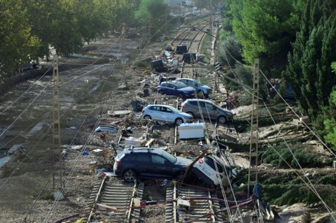 Wrecked cars piled up on the railway in the town of Alfafar