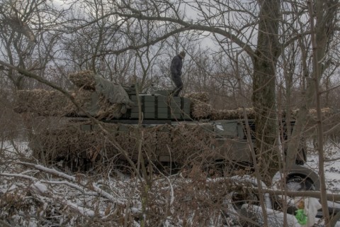 A Ukrainian tank crew member of the 68th Jaeger Brigade stands on a Leopard 1A5 tank near Pokrovsk
