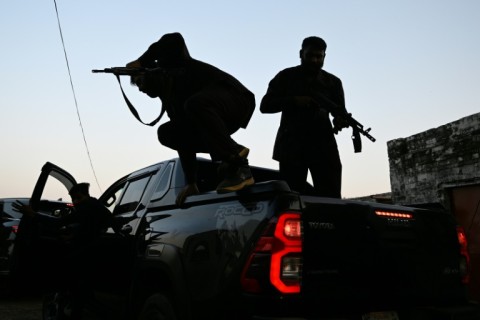 Private security personnel working for politician Ali Warraich, disembark from their Hilux