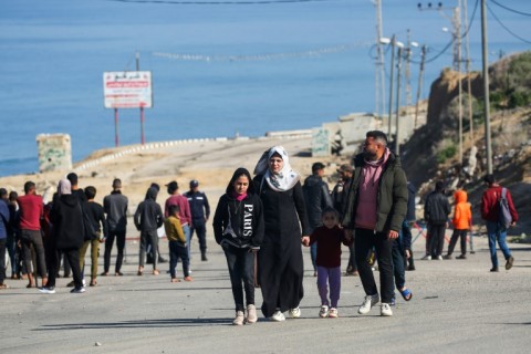 Displaced Palestinians near a roadblock on the way to the Gaza Strip's war-ravaged north