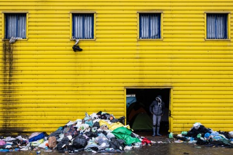 Hundreds of migrants are living in an abandoned warehouse on the outskirts of the port city of Calais