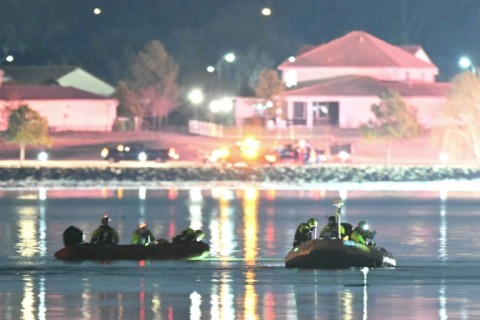 Rescue boats search the Potomac River after a passenger plane on approach to Washington's Reagan National Airport collided with a military helicopter, sending both aircraft crashing into the water