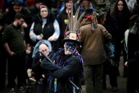 A Morris dancer looks on as he performs during the traditional wassail ceremony