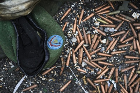 A crumpled Congolese army beret alongside cartridges near an abandoned, bullet-riddled military truck in Goma 