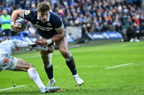 Scotland centre Huw Jones (R) scores one of his three tries against Italy at Murrayfield