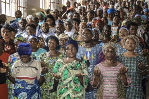 People raise their hands during an interfaith prayer for peace in the Democratic Republic of Congo at a church in Bukavu