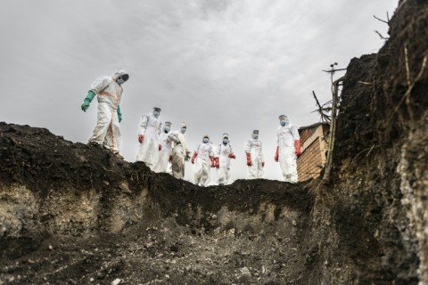 Undertakers line the edge of a portion of a graveyard in Goma, where fresh graves have been dug to accommodate victims of the recent violence