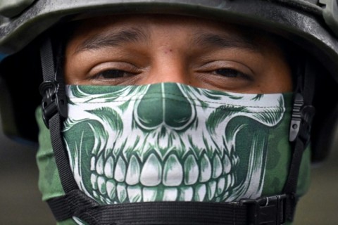 A member of the Armed Forces stands guard at a polling station in Duran, Ecuador, 8 February 2025, on the eve of the presidential elections