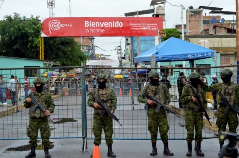 Members of the Armed Forces stand guard in Huaquillas, Southern Ecuador, on the border with Peru on February 8, 2025, on the eve of the presidential election.