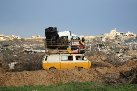 Displaced Palestinians cross the Netzarim Corridor as they make their way to the northern parts of the Gaza Strip