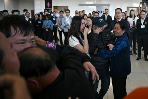 Freed Thai nationals Sathian Suwannkham and Bannawat Saethao, held hostage in Gaza for more than a year, hug family members on their return to Thailand