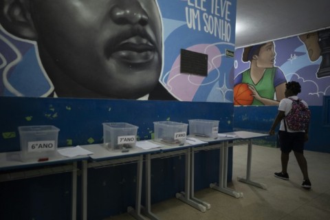 After a year, only a few students now stop under a large mural of the US civil rights hero to place their devices in plastic boxes before heading to class