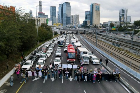 Protesters block a highway in Tel Aviv to demand the release of all hostages held in Gaza after recent develpments threw a truce deal into doubt