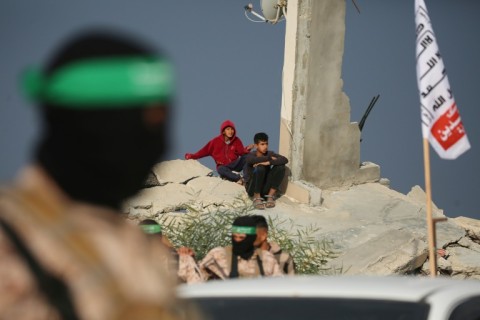 Buildings bombed during more than 15 months of war surrounded the site of the handover of Israeli hostages' bodies by armed Palestinian militants