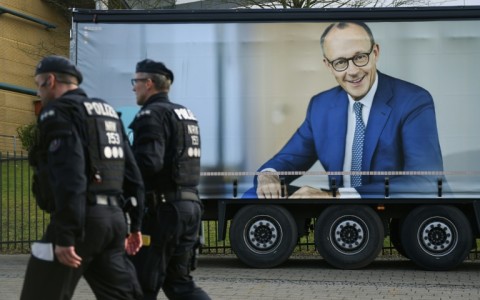 A truck with an election campaign poster featuring Friedrich Merz, leader of the CDU