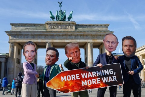 Activists in Berlin stage a protest themed 'More warming, more war', wearing face masks of AfD top candidate Alice Weidel, billionaire Elon Musk, US President Donald Trump, Russian President Vladimir Putin and US Vice President JD Vance