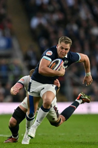 On the run: Scotland wing Duhan van der Merwe bursts past England lock Ollie Chessum at Twickenham