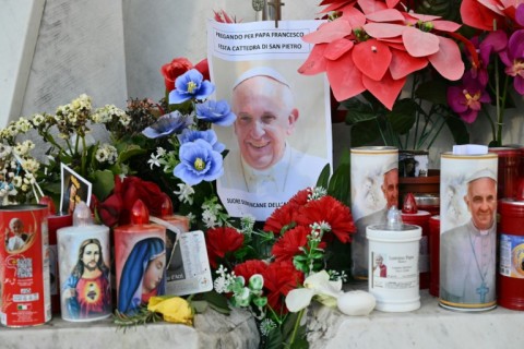 Nuns sing at the statue of John Paul II outside the Gemelli hospital where Pope Francis is hospitalized in Rome 